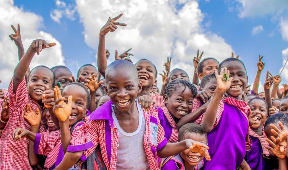 Children in school representing community impact